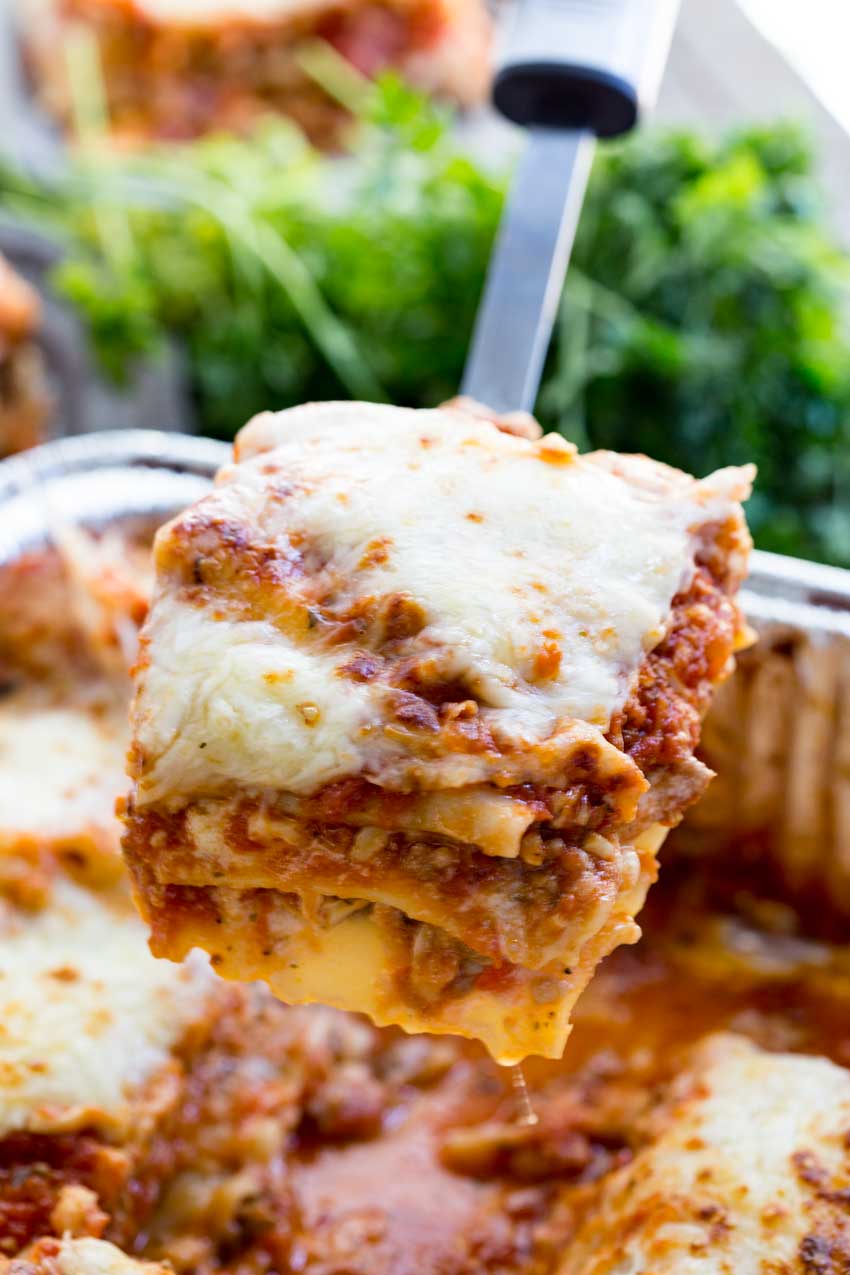 A scoop of traditional meat sauce lasagna with mushrooms