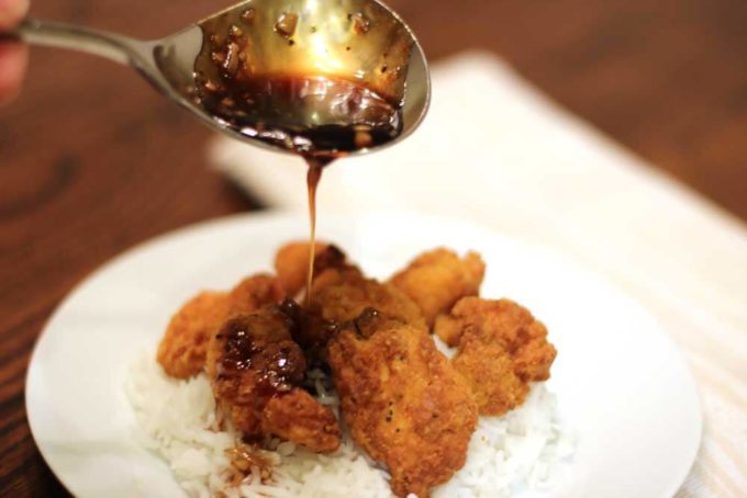 Honey Garlic Chicken spooning sauce over chicken