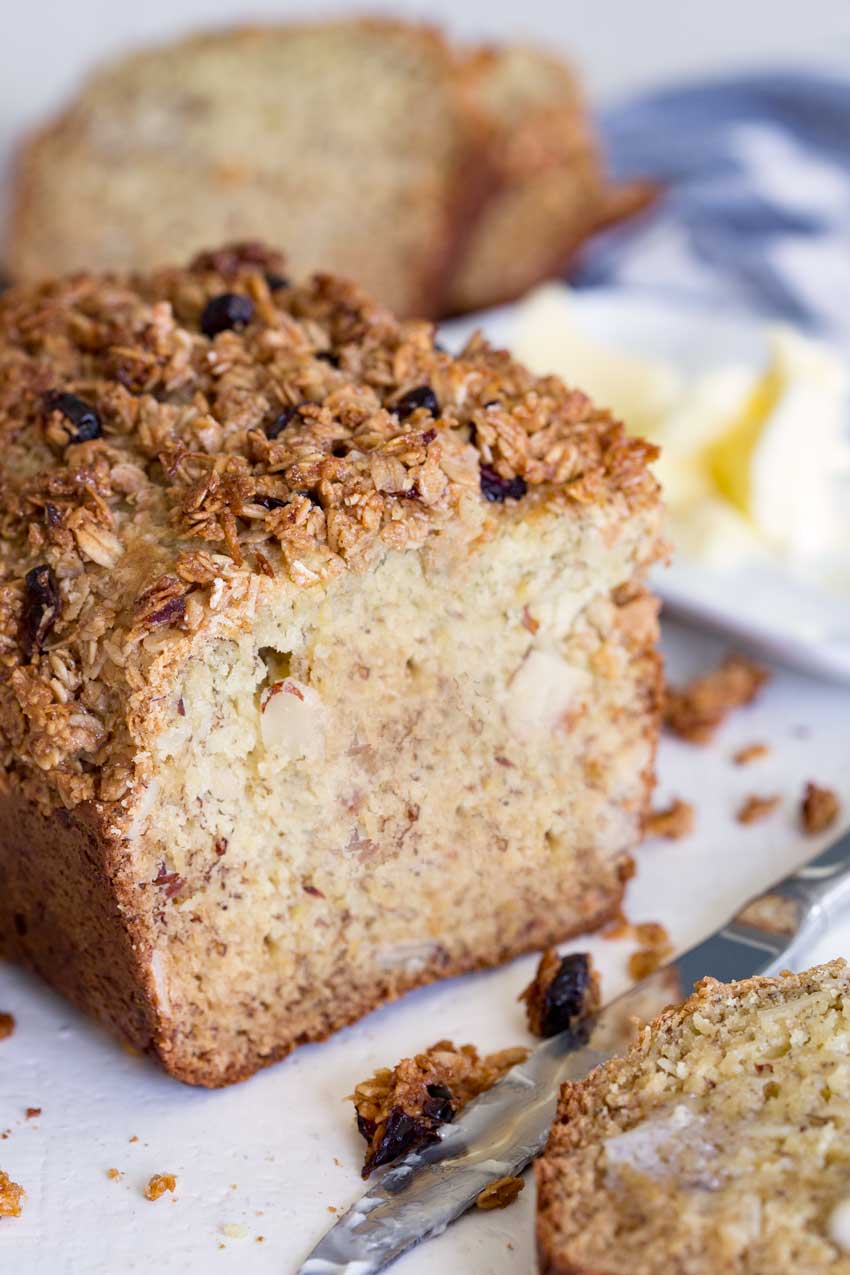 A loaf of cranberry almond granola topped banana bread