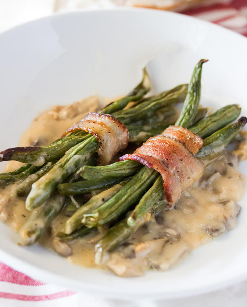 Bacon Wrapped Green Beans with Mushroom Gravy: Features tender green beans that are wrapped in bacon and baked atop a creamy delicious mushroom sauce. Umm good!