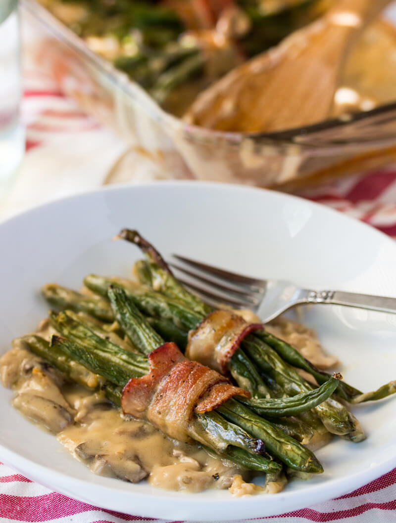 Bacon Wrapped Green Beans: Features tender green beans that are wrapped in bacon and baked atop a creamy delicious mushroom sauce. Umm good!