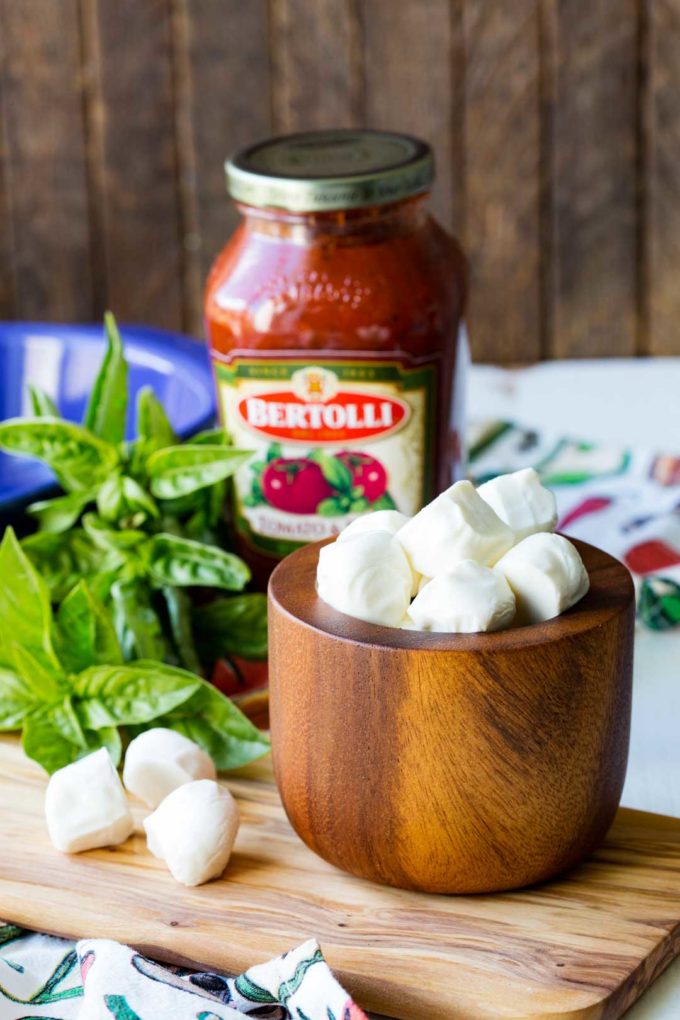 Making caprese baked cheese dip is easy and delicious