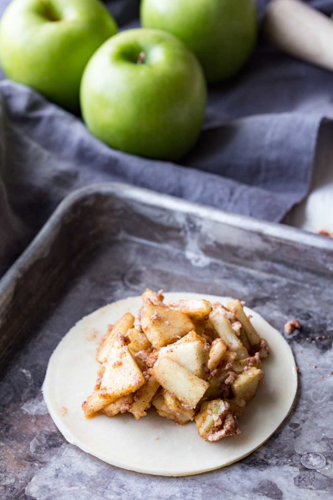 Add filling to pie crust for mummy apple hand pies