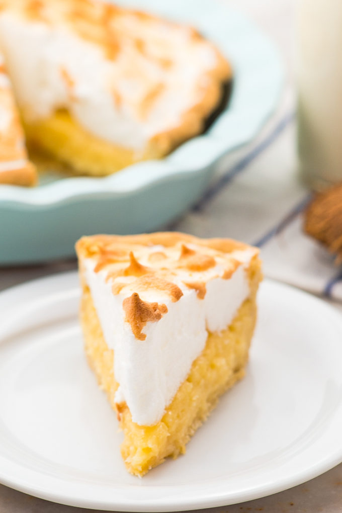 Easy and delicious coconut cream pie, with fluffy meringue on top of a white plate