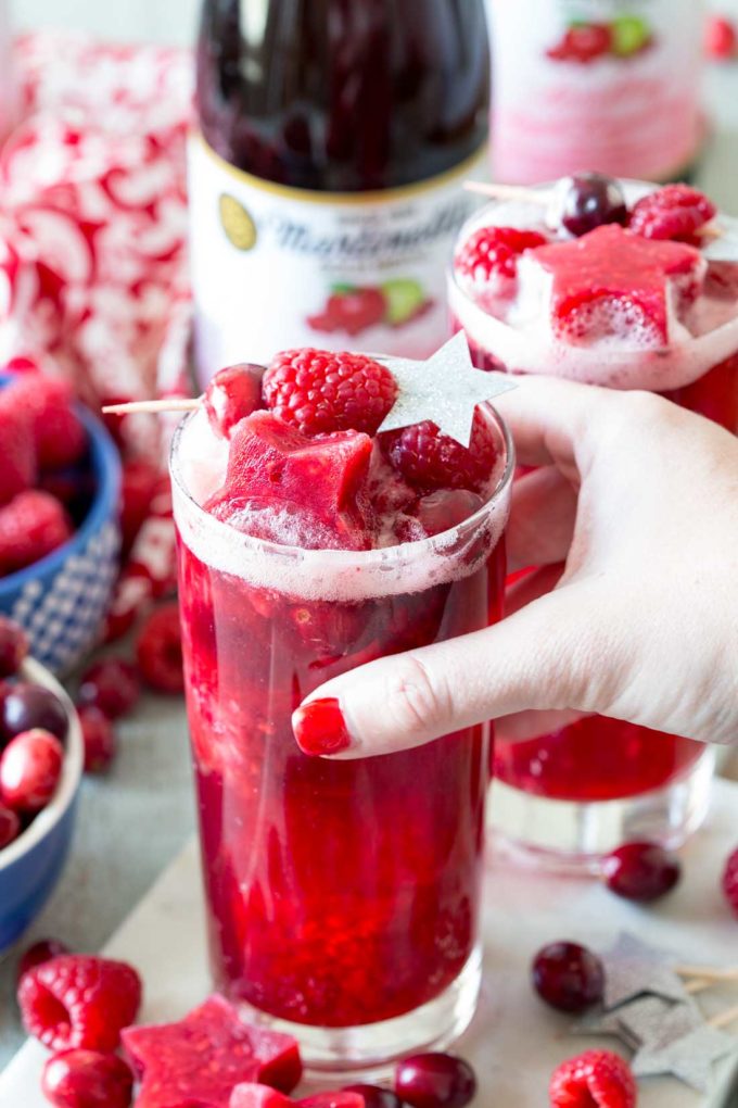 A glass of raspberry cranberry apple sparkling brunch punch