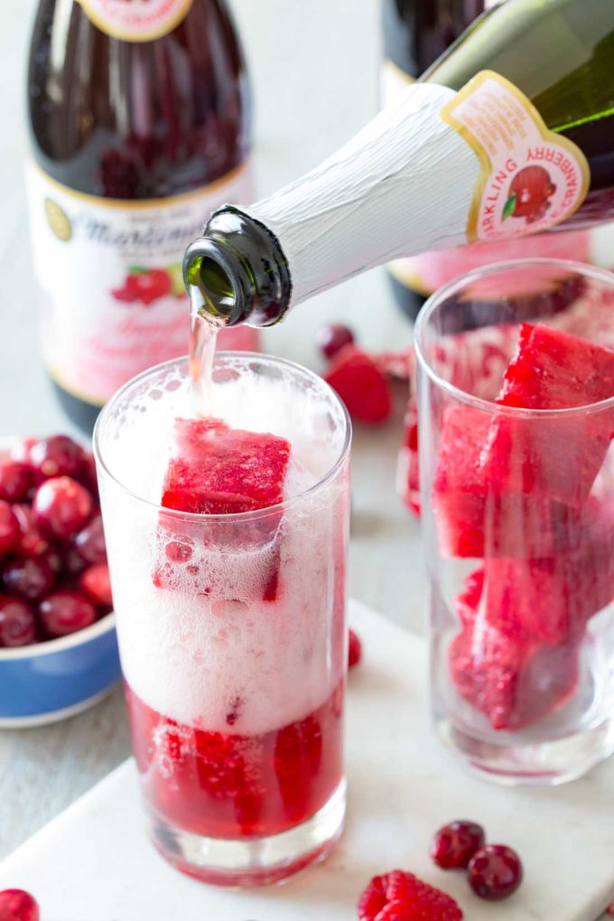 Filling a glass of cranberry apple raspberry brunch punch