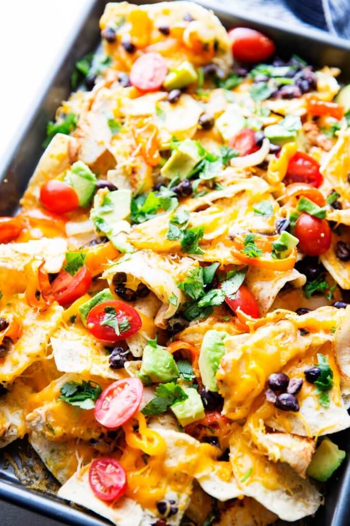 Chicken Nachoes are ultra filling, easy to make, and are loaded with crunchy chips, melty cheese, flavorful chicken, and your favorite toppings! 