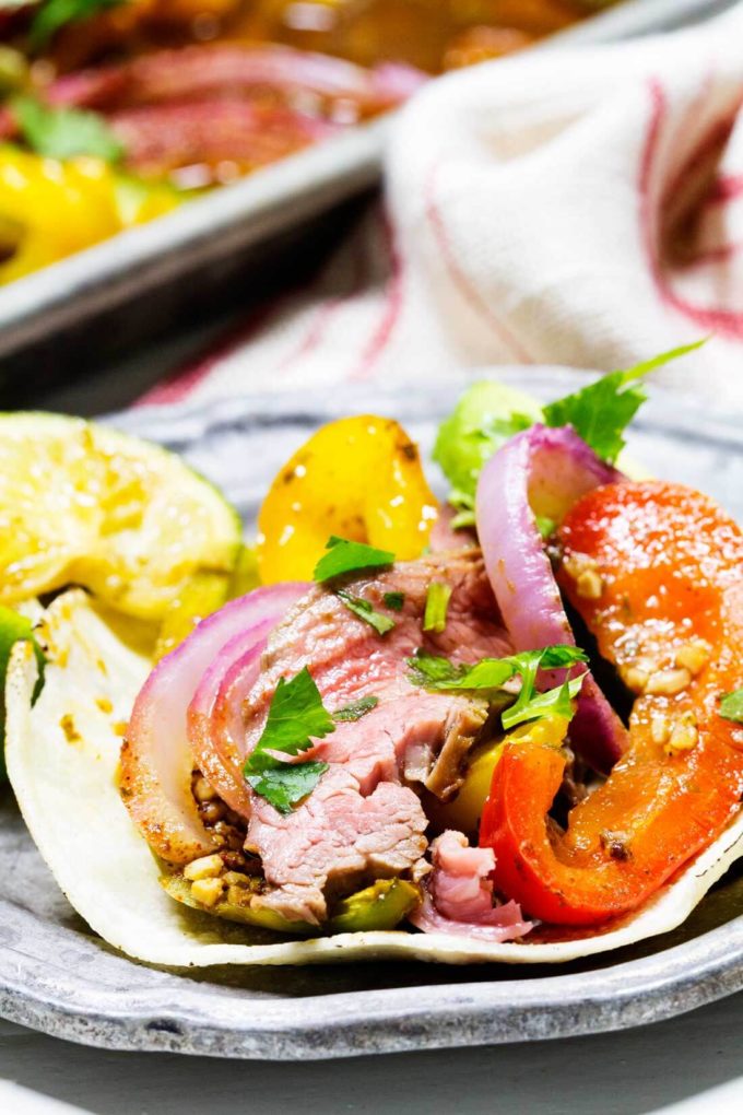 A delicious, tender, packed with flavor fajita flank steak cooked on a single sheetpan