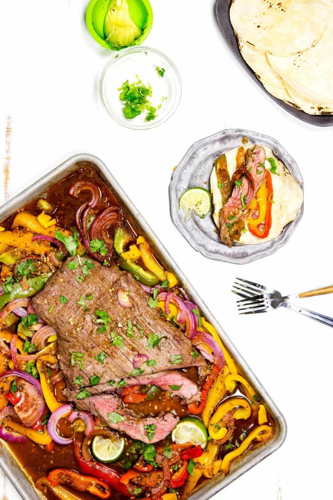 Fajitas cooked on a sheet pan, these flank steak fajitas are made with a marinade to die for!