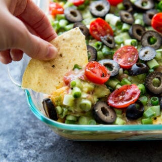 Classic 7 layer cheese dip with a twist. This upgraded 7 layer dip is amazing