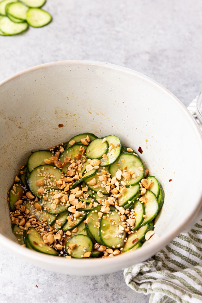 Asian cucumber salad, mixed with asain dressing and topped with sesame and peanuts