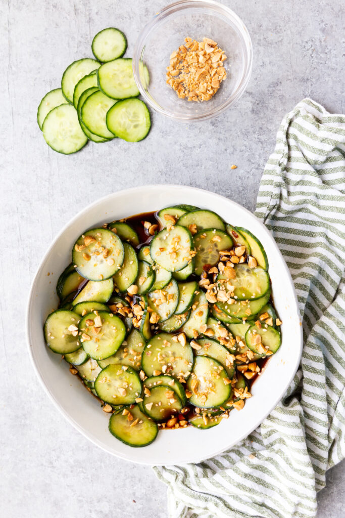 Asian cucumber salad, garnished with sesame seeds and peanuts