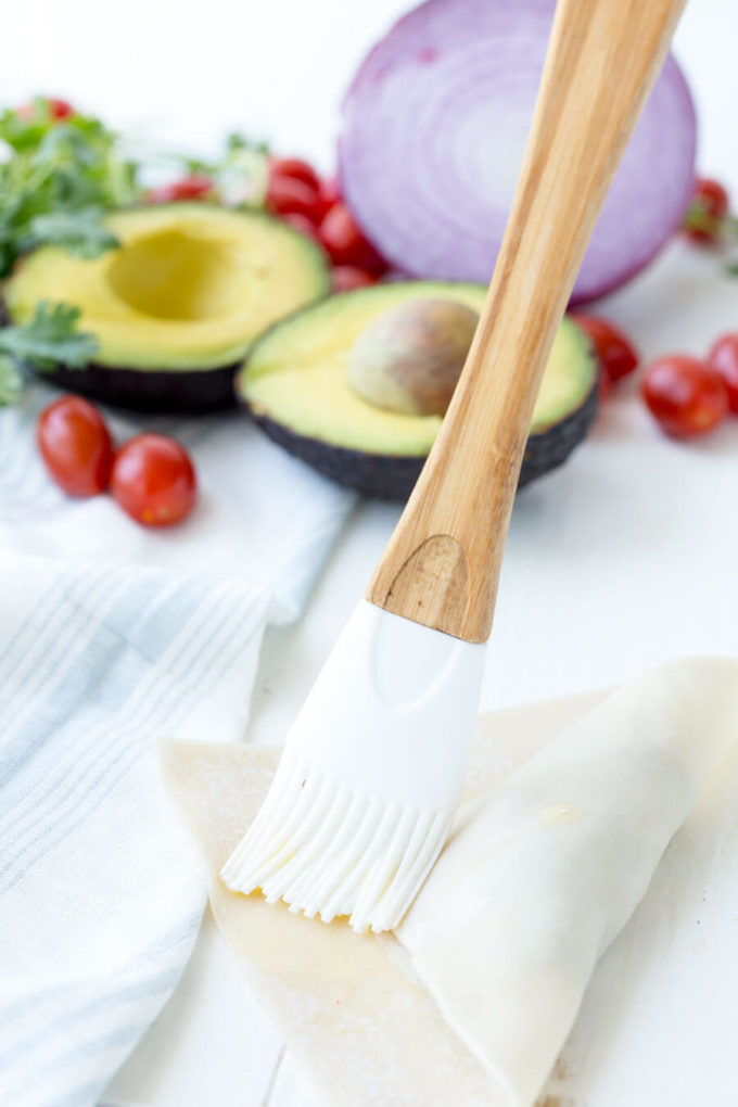 Avocado Egg Rolls: Crunchy egg roll wrapper filled with chunks of California Avocados, cilantro, tomatoes, red onion, and roasted red peppers; dipped in a creamy avocado ranch dipping sauce!