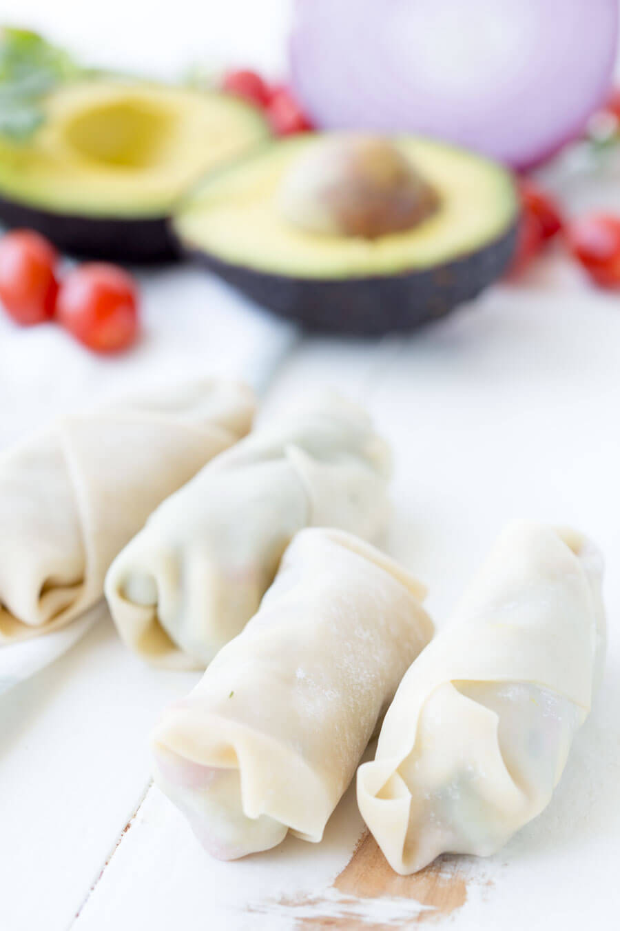 Avocado Egg Rolls: Crunchy egg roll wrapper filled with chunks of California Avocados, cilantro, tomatoes, red onion, and roasted red peppers; dipped in a creamy avocado ranch dipping sauce!