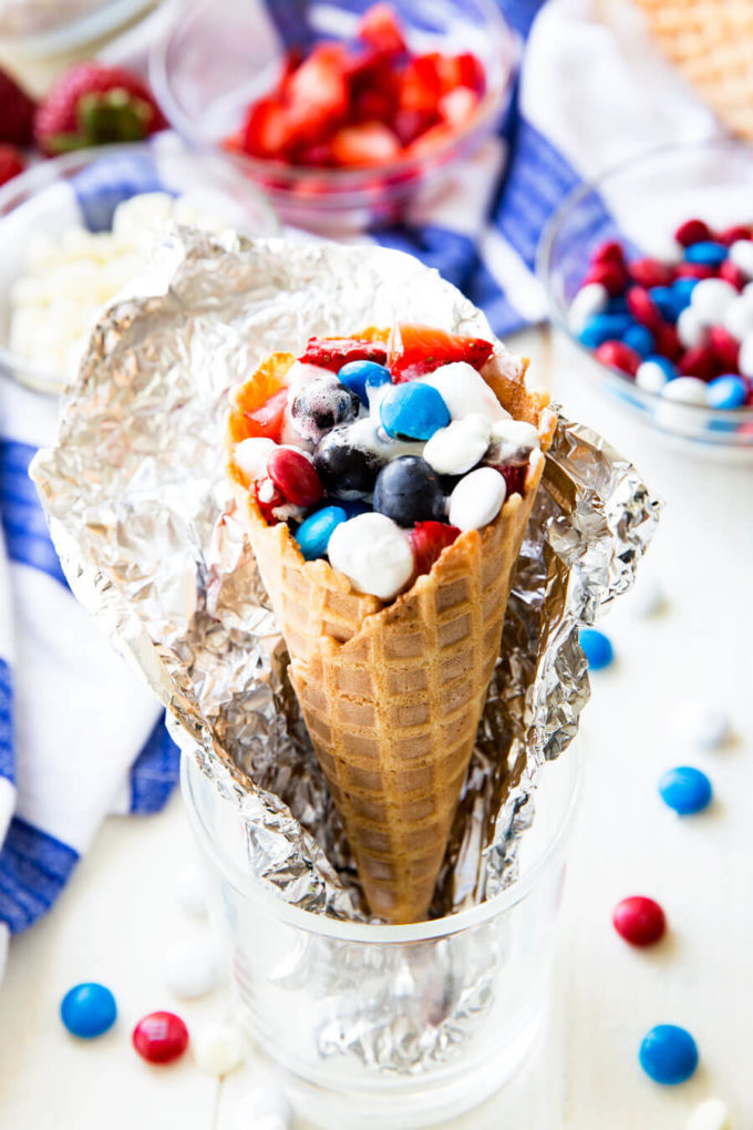 Campfire cones, waffle cones filled with marshmallows, fruit, and chocolate, and cooked in a campfire or oven. 