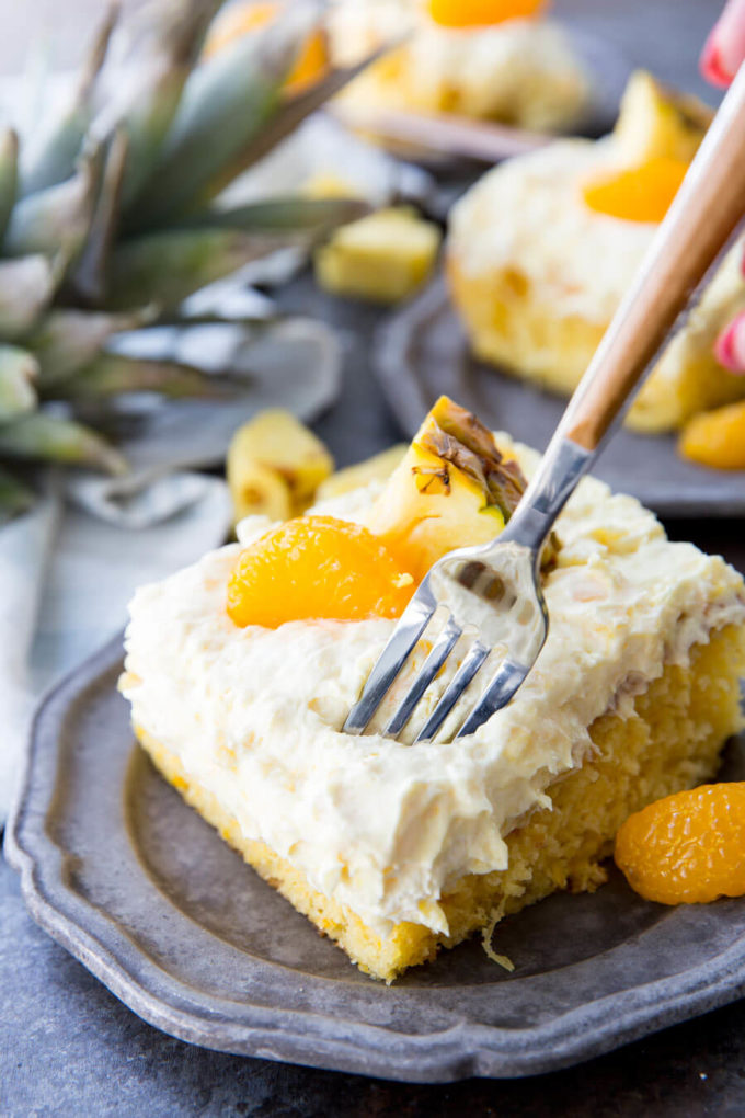 Mandarin Orange Cake with Pineapple fluff frosting or pig pickin' cake is delicious yellow cake with fruity highlights. It is a family favorite