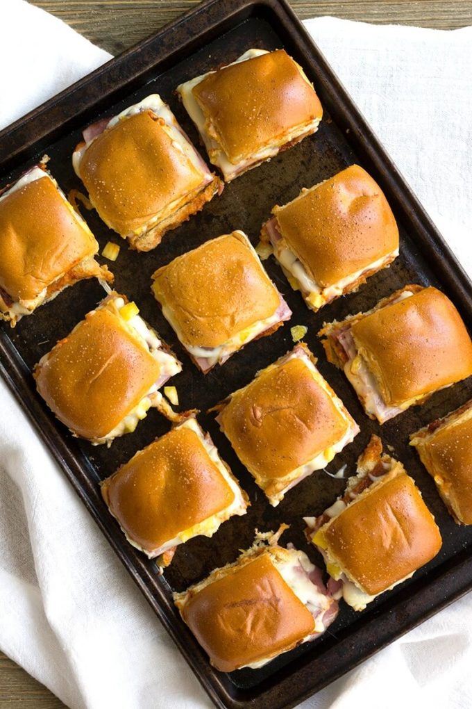 Hawaiian Pizza Sliders are an easy appetizer for your next party that's a sure fire hit! These little bites of deliciousness taste just like your favorite pizza and are ready twice as fast as your local pizzeria!