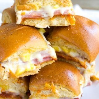 Hawaiian Pizza Sliders are an easy appetizer for your next party that's a sure fire hit! These little bites of deliciousness taste just like your favorite pizza and are ready twice as fast as your local pizzeria!