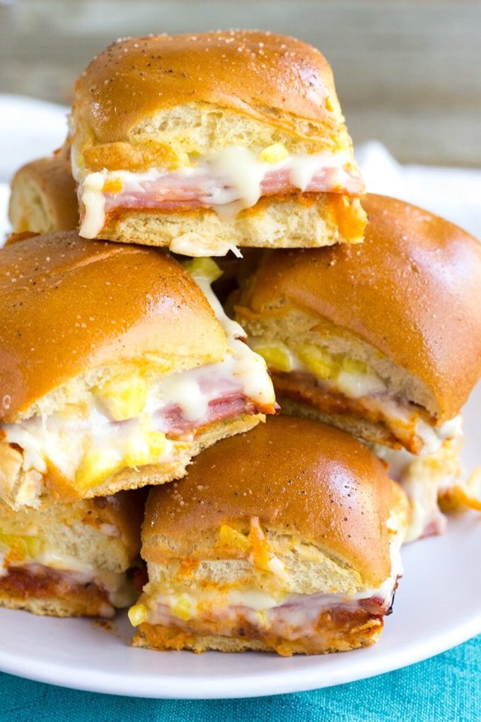 Hawaiian Pizza Sliders are an easy appetizer for your next party that's a sure fire hit! These little bites of deliciousness taste just like your favorite pizza and are ready twice as fast as your local pizzeria!