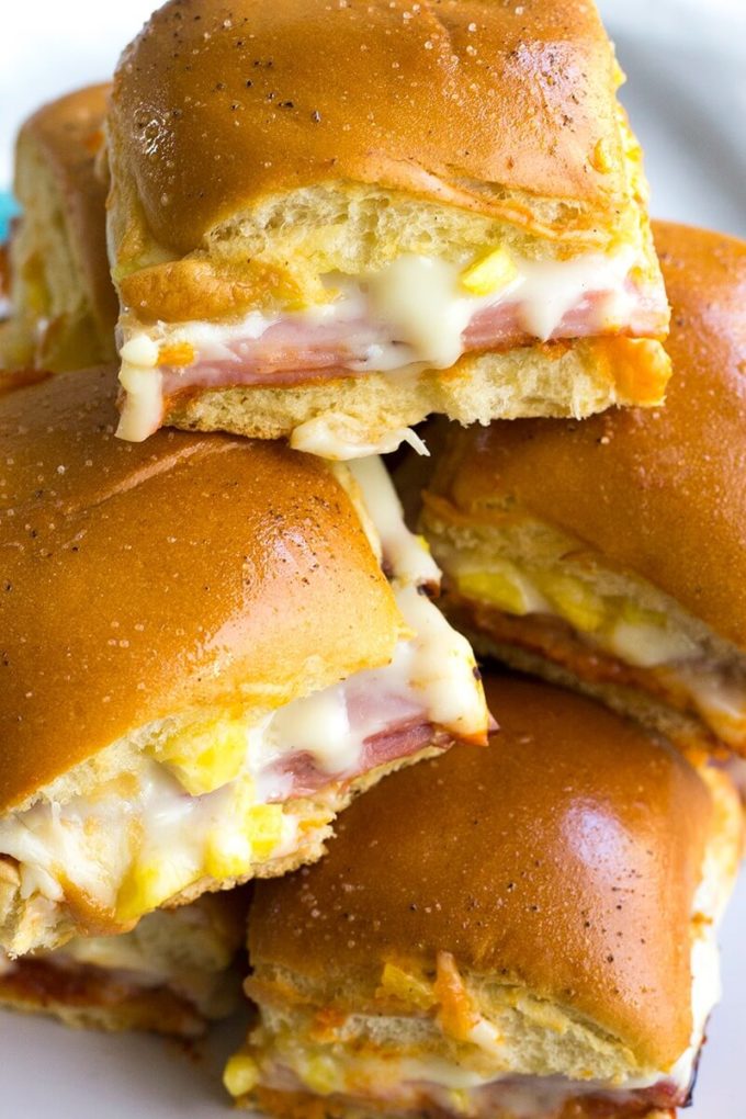 Hawaiian Pizza Sliders are an easy appetizer for your next party that's a sure fire hit! These little bites of deliciousness taste just like your favorite pizza and are ready twice as fast as your local pizzeria!