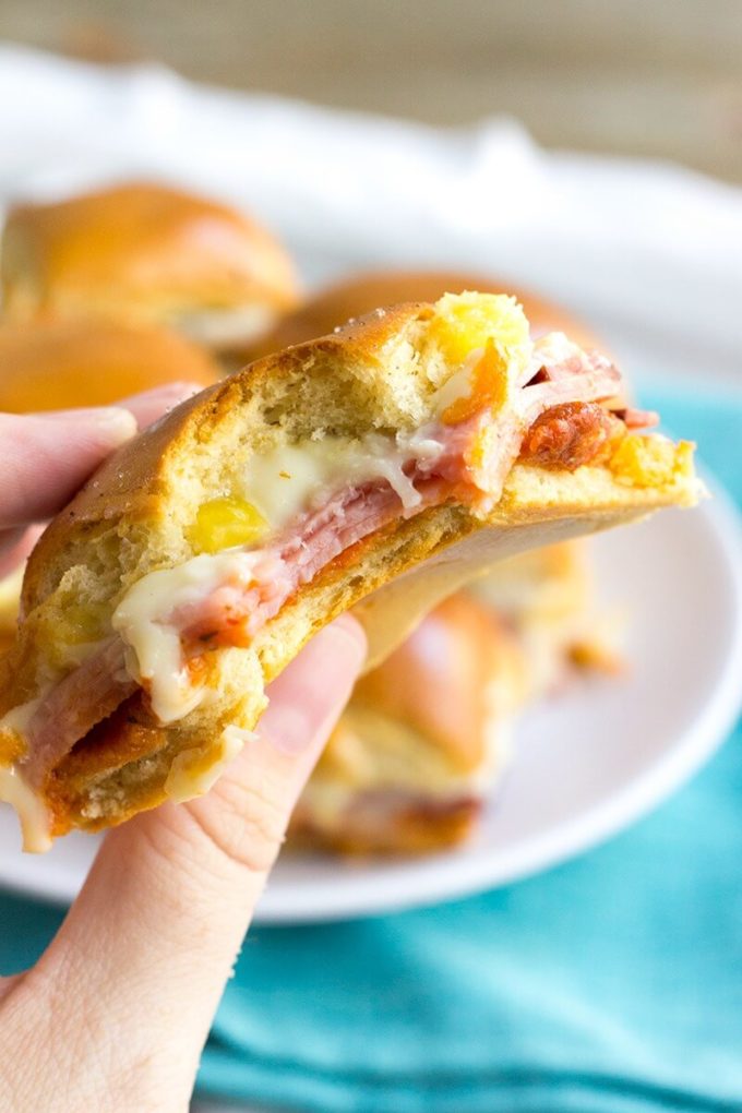 Hawaiian Pizza Sliders are an easy appetizer for your next party that's a sure fire hit! These little bites of deliciousness taste just like your favorite pizza and are ready twice as fast as your local pizzeria!