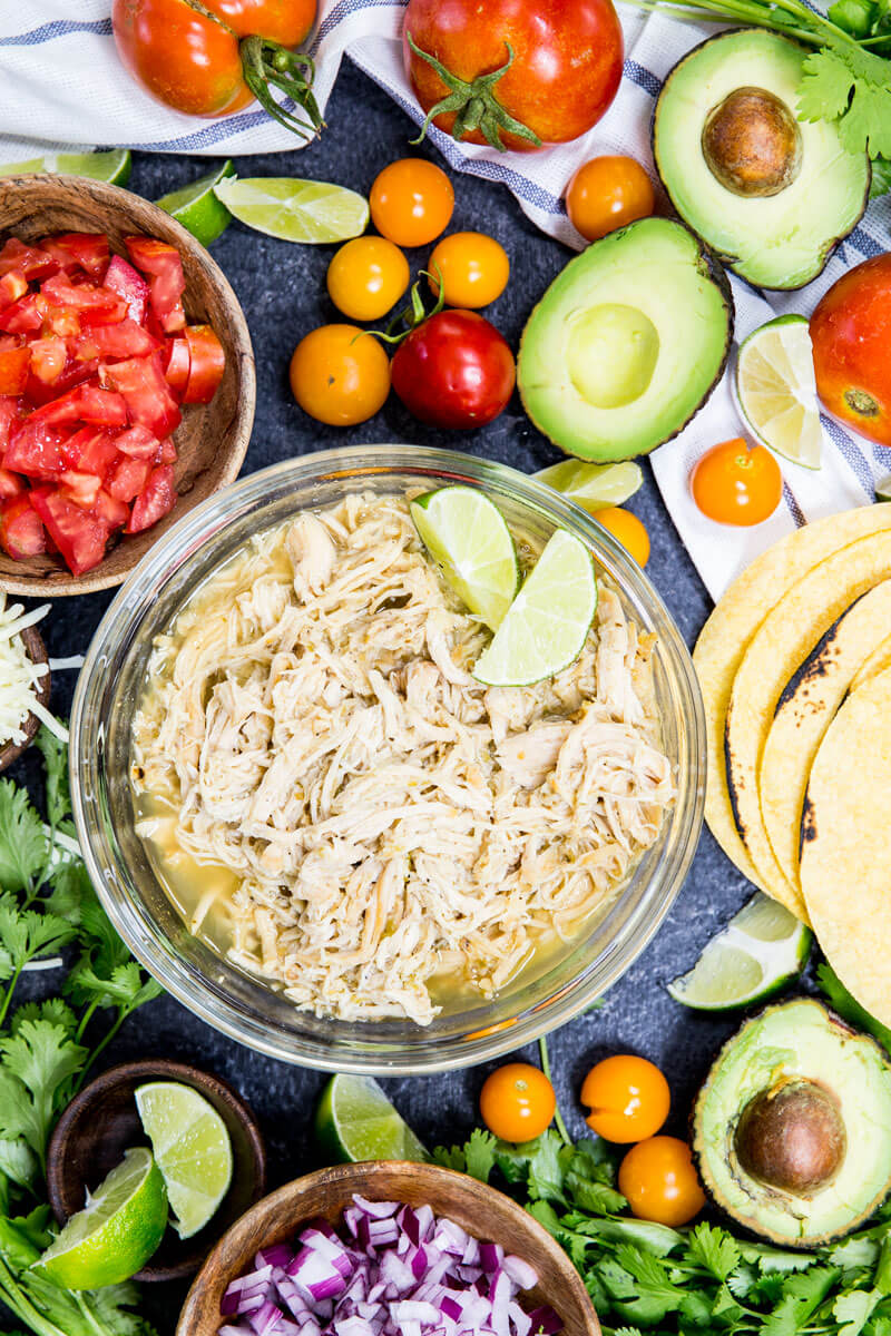 Slow Cooker Honey Lime Chicken Tacos are cooked in the slow cooker, shredded, and used in tacos, burritos, nachos, etc. It is flavor packed and super delicious. 