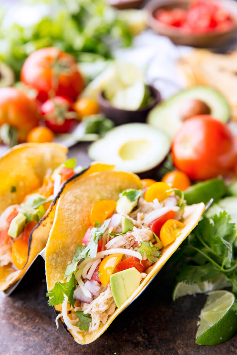 Honey Lime Chicken Tacos are cooked in the slow cooker, shredded, and used in tacos, burritos, nachos, etc. It is flavor packed and super delicious.