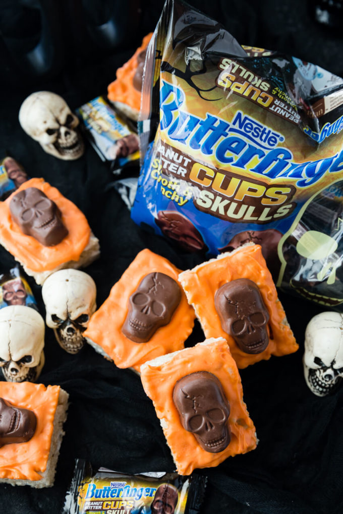 Deliciously easy to make Halloween Rice Krispie Treats with Butterfinger Peanut Butter Skulls