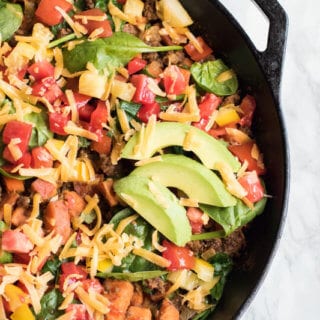 Southwestern sweet potato and ground beef skillet is loaded with fresh veggies and topped with cheese and avocado. A healthy, easy, and insanely delicious dinner that your whole family will love. Ready in 30 minutes!