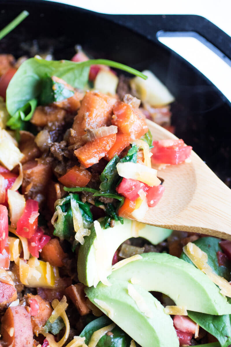 Southwestern sweet potato and ground beef skillet is loaded with fresh veggies and topped with cheese and avocado. A healthy, easy, and insanely delicious dinner that your whole family will love. Ready in 30 minutes!