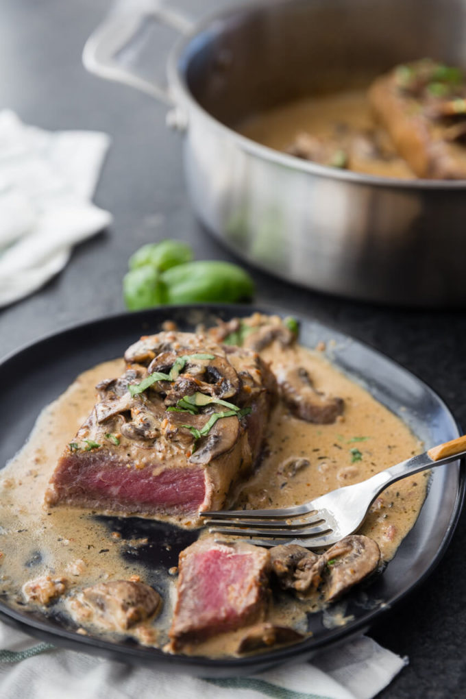 Garlic Parmesan Mushroom Cream Sauce on top of a delicious pan seared steak