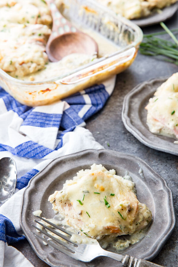 monte cristo chicken with two grey plates, baking dish and blue towel