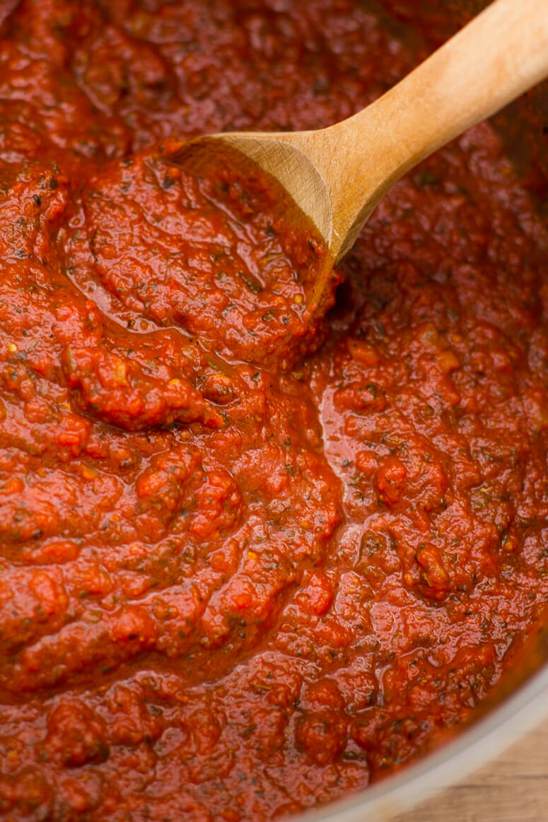 Homemade Spaghetti sauce in a pot with a wooden spoon