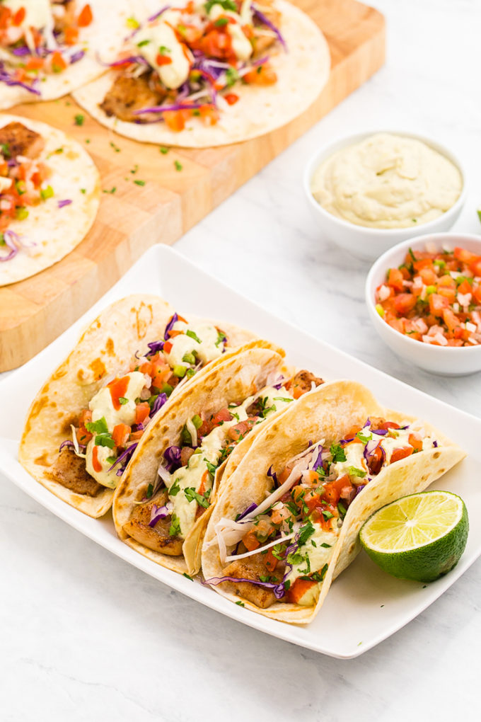 Absolutely amazing Lightened up delicious Baja Fish Tacos, so much flavor in these fish tacos with avocado cream sauce