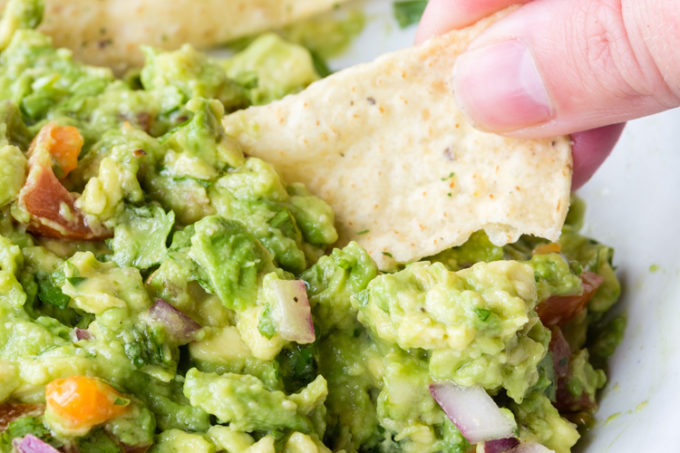 Easy to make guacamole with fresh avocado, onions, tomato, cilantro, lime juice