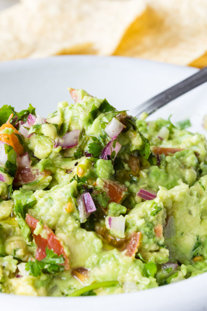 How to make delicious guacamole with fresh avocados and other fixings like cilantro, red onion, lime juice, etc.