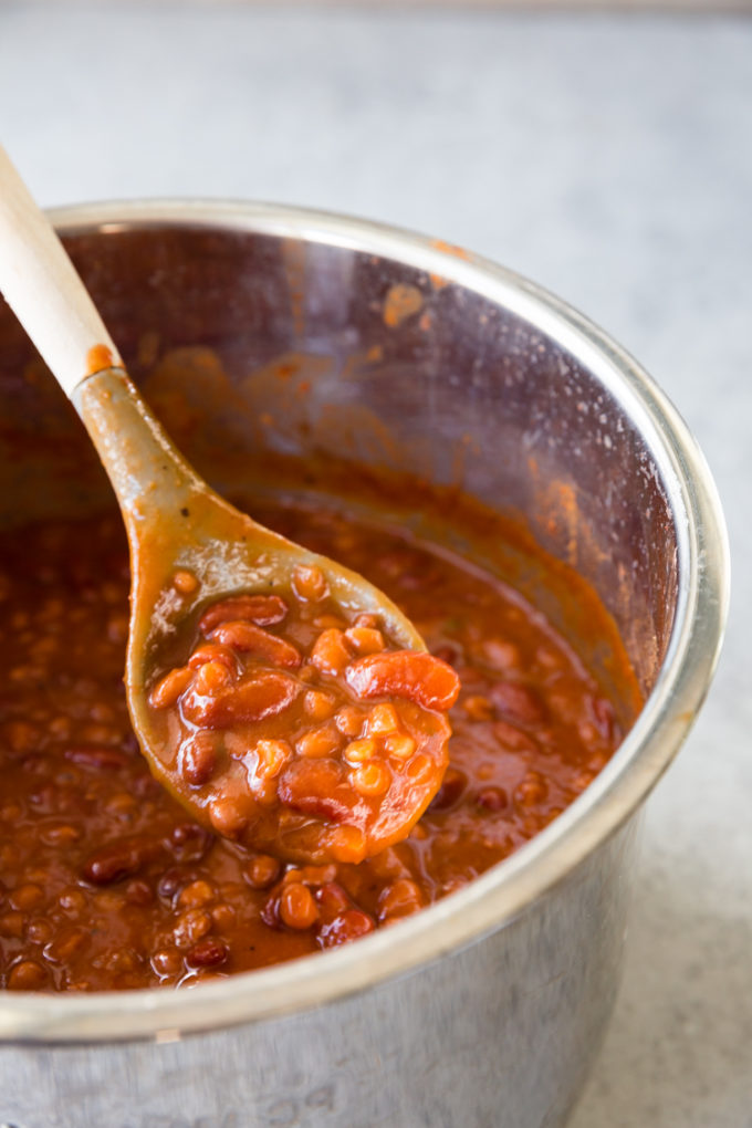 Instant Pot baked beans in the instant pot liner with a spoonful of baked beans