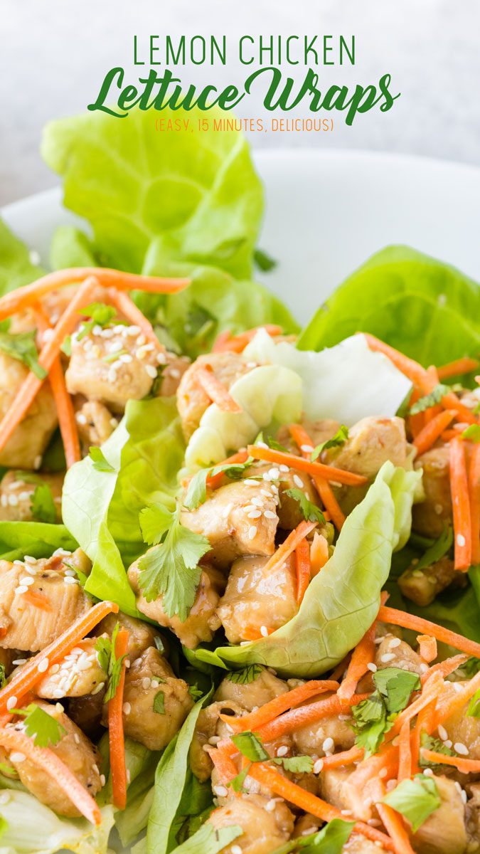 A plate full of lemon chicken lettuce wraps: tender chicken topped with matchstick carrots, toasted sesame seeds, and cilantro. Great summer brunch food. 