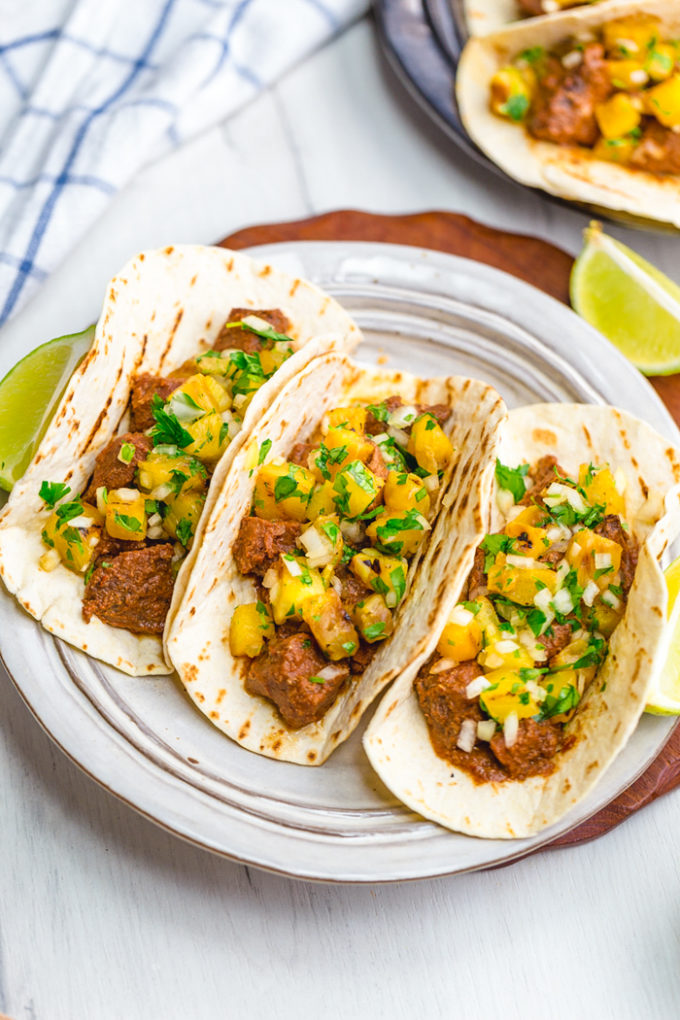 Tacos al Pastor: Delicious Pastor meat and grilled pineapple pico wrapped in a hot grilled tortilla. This tacos al pastor recipe is perfect for a weeknight dinner or a summer night barbecue. It is easier than traditional and uses easy to find ingredients. 