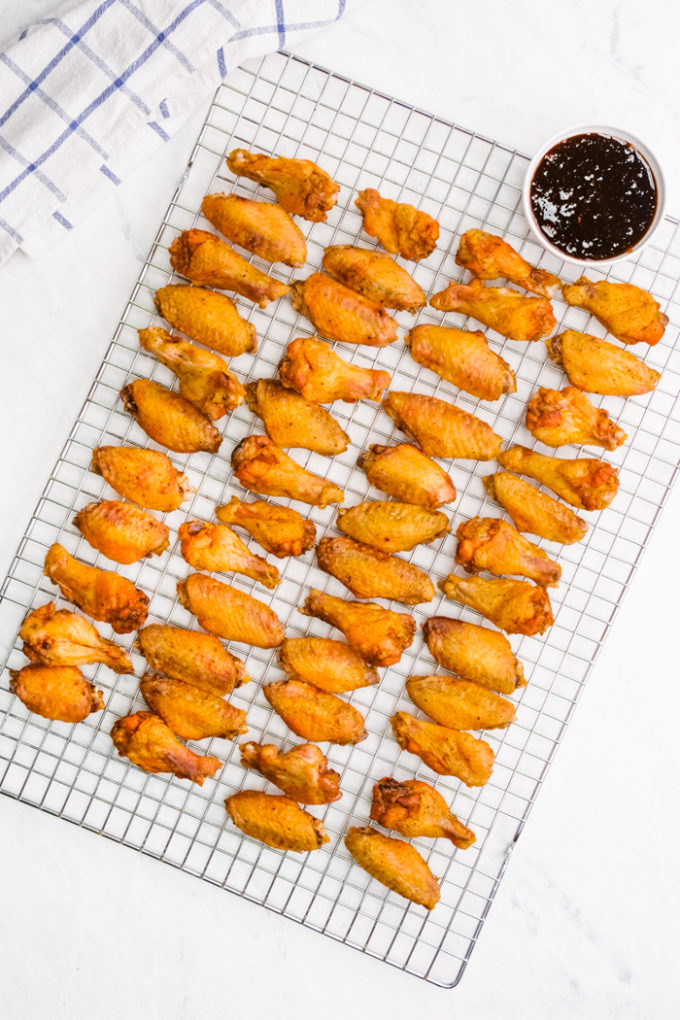 Oven baked and crispy wings on a cooling rack