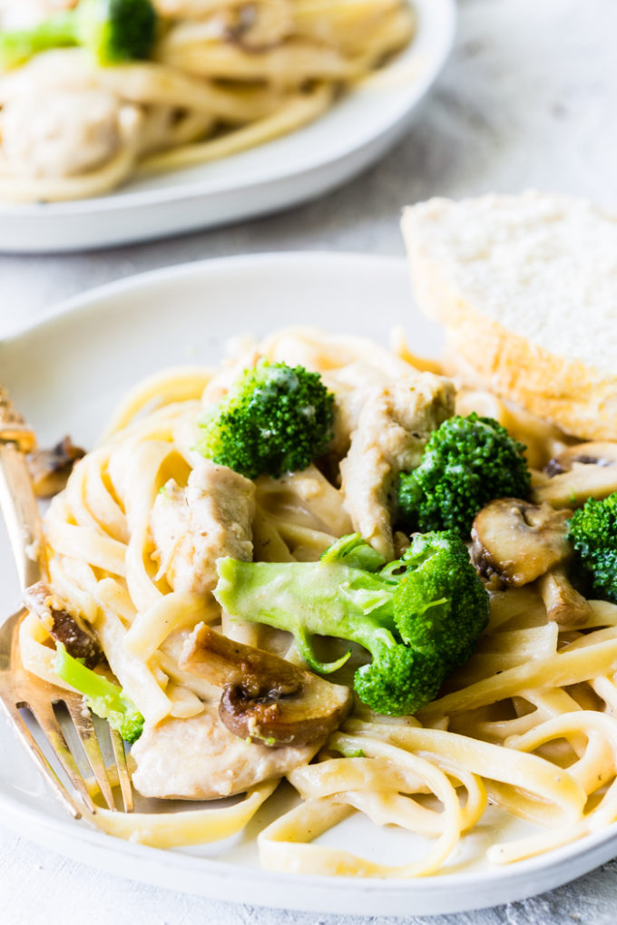 A delicious plate of lactose free fettuccine Alfredo with chicken and broccoli