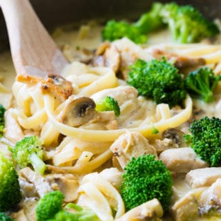 A delicious pot of fettuccine Alfredo with mushrooms, broccoli, and chicken