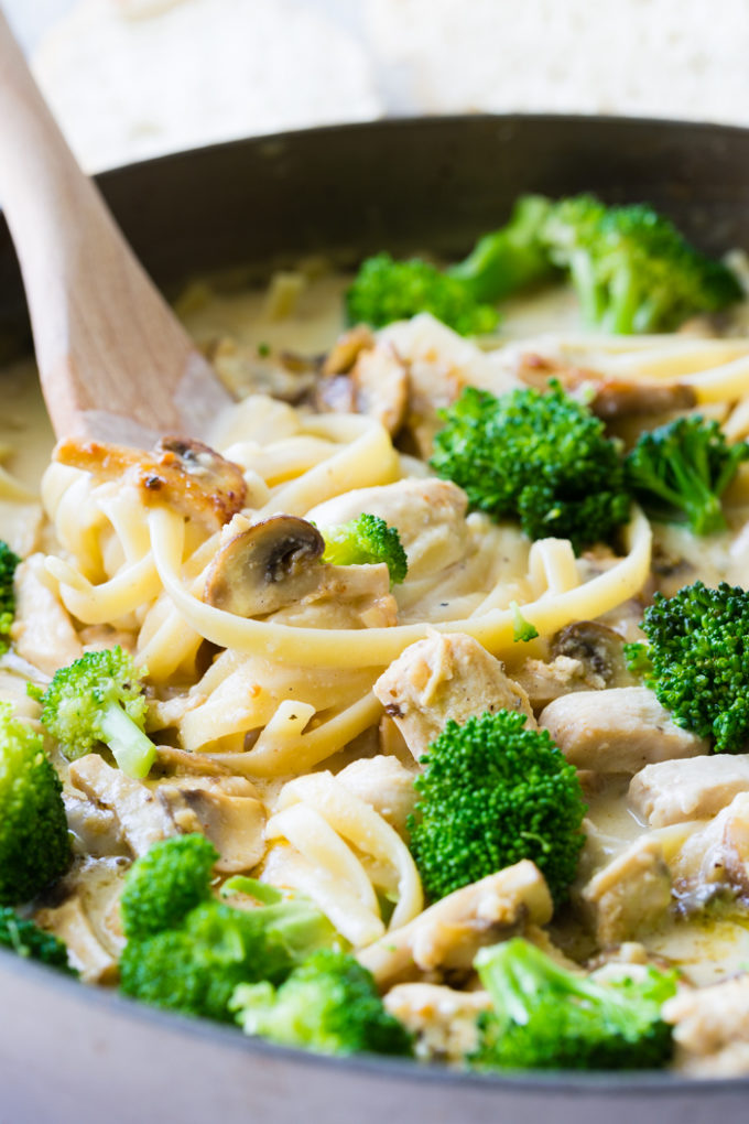 A delicious pot of fettuccine Alfredo with mushrooms, broccoli, and chicken