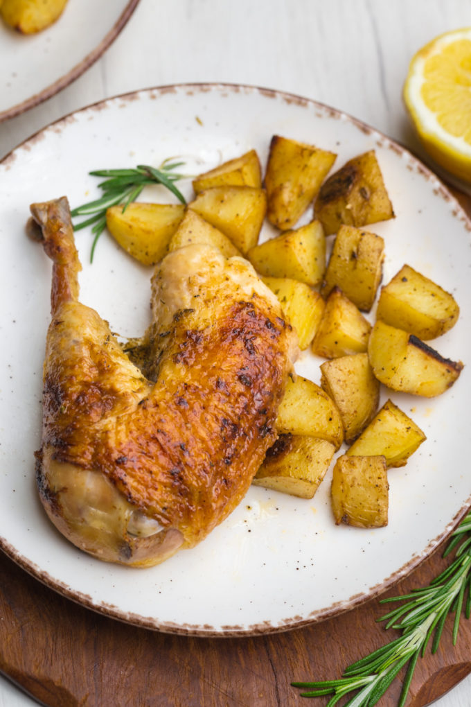 Delicious roast chicken, a whole roasted chicken leg and thigh with roast potatoes. 