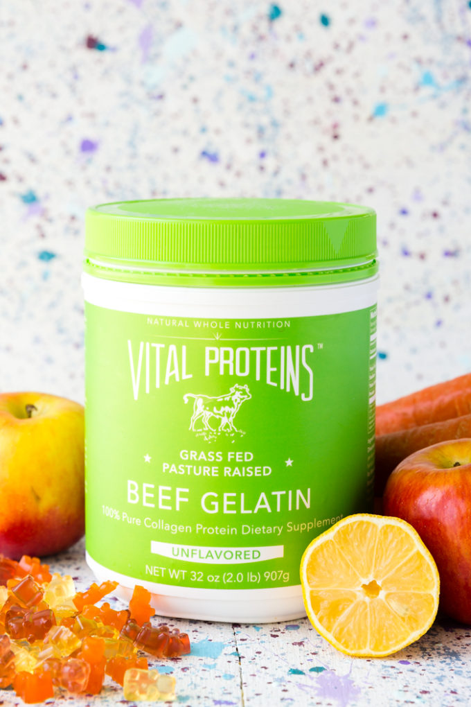 Vital Proteins Beef Gelatin surrounded by fresh fruit and gummy candy