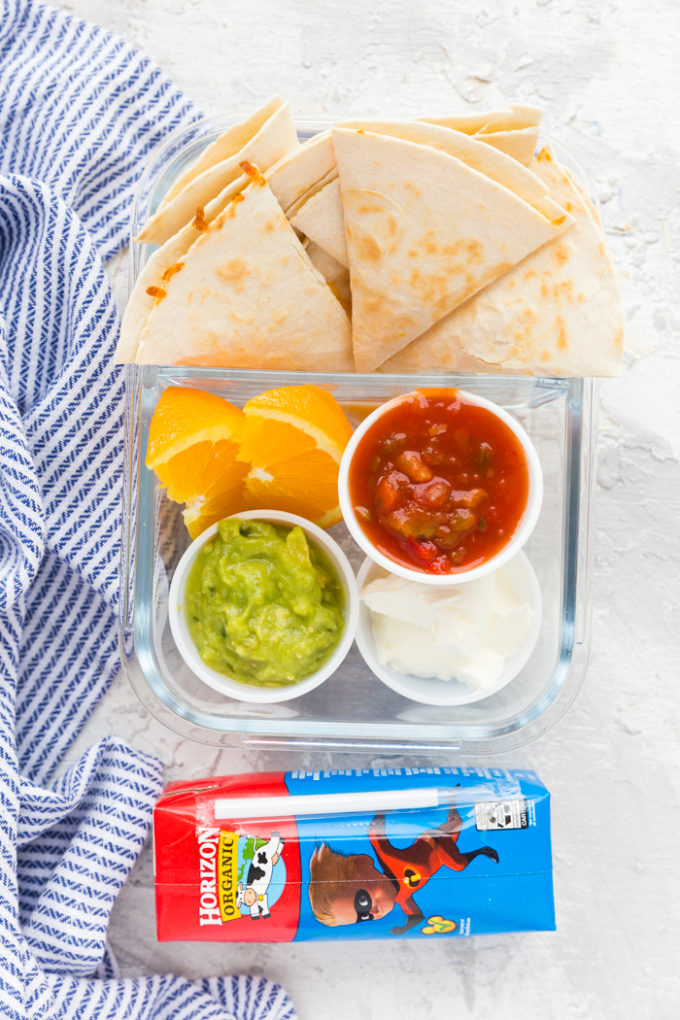 Quesadilla triangles, guacamole, salsa, and sour cream, oranges