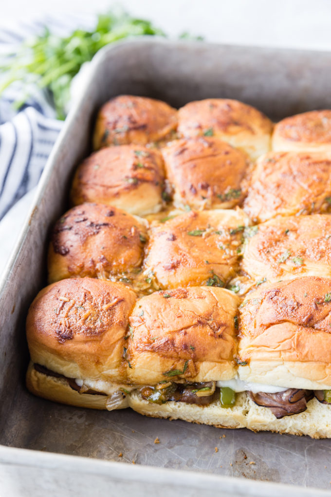 A pan full of Philly cheese steak sliders after being cooked