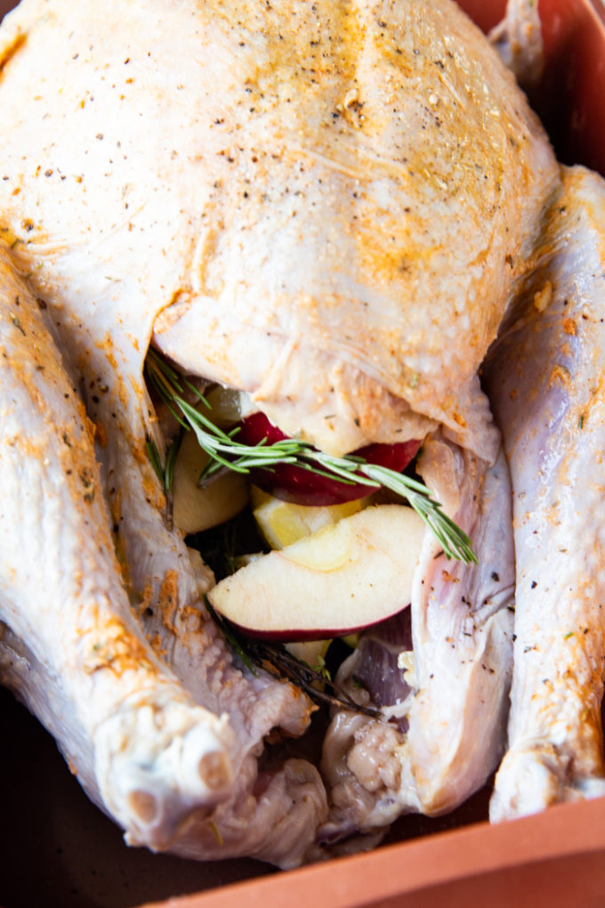 Roast turkey with herb butter rub and aromatics stuffed in the cavity