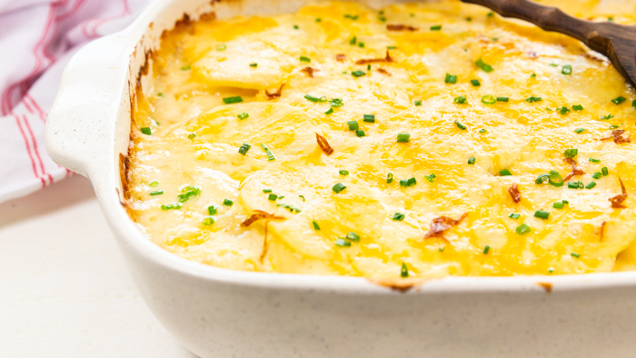 Creamy scalloped potatoes in a white casserole dish