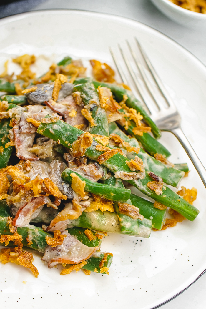 A white plate with classic green bean casserole on top